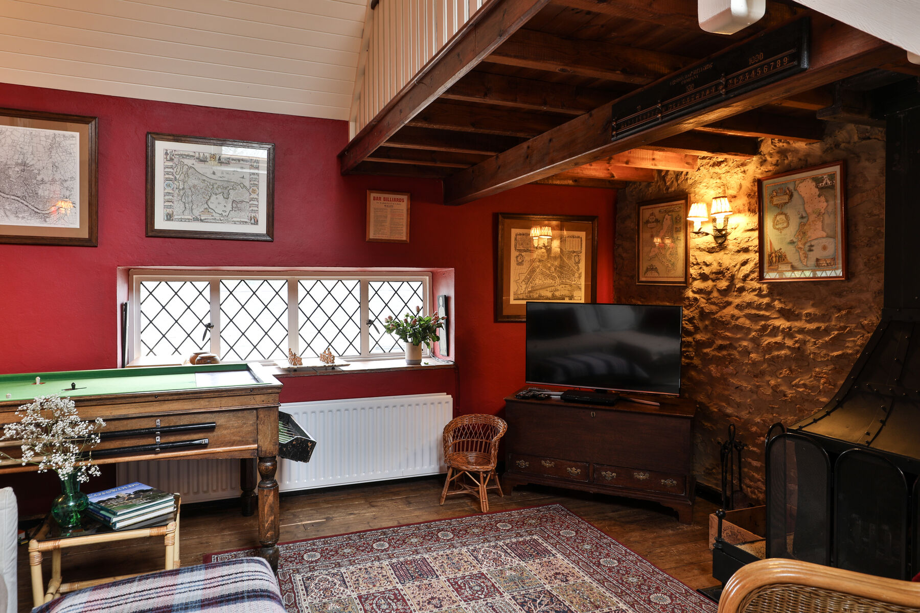 The Minstrels' Gallery with piano, fireplace and bar billiards